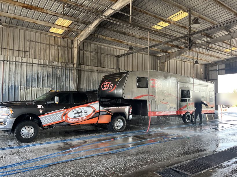 The wrapped 3B's truck and its service trailer at a truck wash